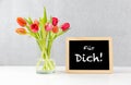 Colorful tulips in a Vase with german text fÃÂ¼r dich, in english for you