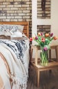 Colorful tulips in vase are in modern bedroom Royalty Free Stock Photo