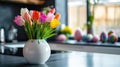 Colorful tulips in a white vase on a modern kitchen counter Royalty Free Stock Photo