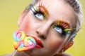 Colorful twisted lollipop and colorful extreme fashion makeup