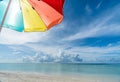 Colorful umbrella on paradise white sand beach and blue sky in sandbank island, Maldives