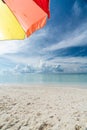 Colorful umbrella on paradise white sand beach and blue sky in sandbank island, Maldives Royalty Free Stock Photo