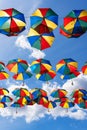 Colorful umbrellas background. Coloruful umbrellas urban street decoration. Hanging Multicoloured umbrellas over blue Royalty Free Stock Photo