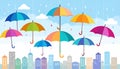Colorful umbrellas float in a light rain over a city skyline Royalty Free Stock Photo