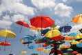 Colorful umbrellas flying in the summer blue sky.