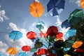 Colorful umbrellas flying in the summer blue sky.