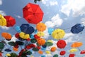 Colorful umbrellas flying in the summer blue sky.