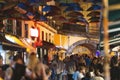 Colorful umbrellas over the street of Portugal - people walk around the city in the evening near a cafe Royalty Free Stock Photo