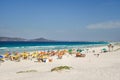 colorful umbrellas and tourists crowd the sand line at Praia do Forte in Cabo Frio, Rio de Janeiro, Brazil Royalty Free Stock Photo