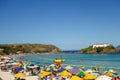 colorful umbrellas and tourists crowd the sand line at Praia do Forte in Cabo Frio, Rio de Janeiro, Brazil Royalty Free Stock Photo