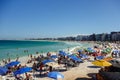 colorful umbrellas and tourists crowd the sand line at Praia do Forte in Cabo Frio, Rio de Janeiro, Brazil Royalty Free Stock Photo