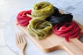 Colorful Uncooked Pasta on Wooden Board with Copyspace Royalty Free Stock Photo