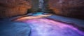 Colorful underground cave with glowing water Royalty Free Stock Photo