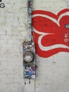 Colorful Urban Background: Electric Meter with Graffiti Stickers on Painted Urban Brick Wall. Royalty Free Stock Photo