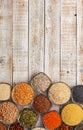 Colorful variety of grains, seeds and nuts on the white wooden table