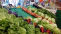 Colorful Vegetable Display with Cabbage and Carrots at a Bustling Market Stall Royalty Free Stock Photo