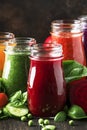 Colorful vegetable juices and smoothies from tomato, carrot, pepper, cabbage, spinach, beetroot in bottles on kitchen table, vegan Royalty Free Stock Photo