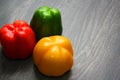 Colorful vegetables and peas, yellow, green and red bell peppers on vintage gray wooden background Royalty Free Stock Photo