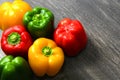 Colorful vegetables and peas, yellow, green and red bell peppers on vintage gray wooden background Royalty Free Stock Photo