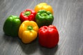 Colorful vegetables and peas, yellow, green and red bell peppers on vintage gray wooden background Royalty Free Stock Photo