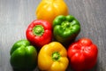 Colorful vegetables and peas, yellow, green and red bell peppers on vintage gray wooden background Royalty Free Stock Photo