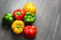 Colorful vegetables and peas, yellow, green and red bell peppers on vintage gray wooden background Royalty Free Stock Photo