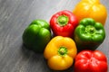 Colorful vegetables and peas, yellow, green and red bell peppers on vintage gray wooden background Royalty Free Stock Photo