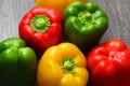 Colorful vegetables and peas, yellow, green and red bell peppers on vintage gray wooden background Royalty Free Stock Photo