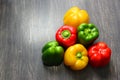 Colorful vegetables and peas, yellow, green and red bell peppers on vintage gray wooden background Royalty Free Stock Photo
