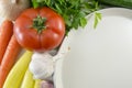 Colorful vegetables on the table and big white plate for prepari Royalty Free Stock Photo