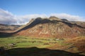 Colorful vibrant Autumn landscape image looking from Pike O`Blisco towards Langdale Pikes and Range with beautiful sungiht on Royalty Free Stock Photo