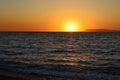 Colorful vibrant orange sunset on the seaside. Golden hour sunlight. Majestic dusk. Seascape in Rhodes, Greece