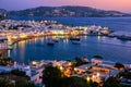 Colorful view after sunset of Mykonos, Greece, harbor and port, ships, whitewashed houses. Town lights up. Vacations Royalty Free Stock Photo