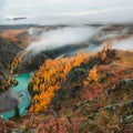 Colorful view to autumn mountain valley with forest and river against mountain range under cloudy sky. Wide mountain valley in Royalty Free Stock Photo