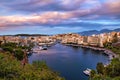 Colorful view of Voulismeni lake and Agios Nikolaos town on Crete island, Greece at sunset with beautiful clouds on blue Royalty Free Stock Photo