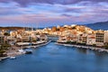 Colorful view of Voulismeni lake and Agios Nikolaos town on Crete island, Greece at sunset with beautiful clouds on blue Royalty Free Stock Photo