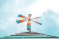 Colorful vintage cute iron wind turbine on the wooden roof.