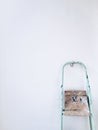 Colorful vintage ladder at a white wall ready to craft and work at home