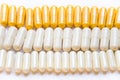 Colorful vitamins in capsules lying in a row