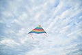 Young brunette woman, wearing casual clothes green t-shirt, playing with colorful kite on green field meadow in summer, running, Royalty Free Stock Photo