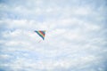 Young brunette woman, wearing casual clothes green t-shirt, playing with colorful kite on green field meadow in summer, running, Royalty Free Stock Photo