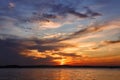 Colorful vivid sky over lake in the evening sunset. Beautiful color clouds shining on bright sunlight Royalty Free Stock Photo