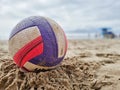 Colorful voley ball resting on the beach sand Royalty Free Stock Photo