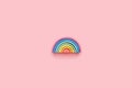 Colorful Waldorf wooden rainbow in a montessori teaching pedagogy on pink background