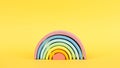 Colorful Waldorf wooden rainbow on yellow background, montessori teaching pedagogy