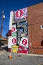 A colorful wall mural of beer cans from Reformation Brewery on the side of a red brick buildings in Little Five Points