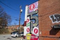 A colorful wall mural of beer cans from Reformation Brewery on the side of a red brick buildings in Little Five Points