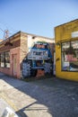 A colorful wall mural of a blue Ford Monster truck on the side of a red brick buildings in Little Five Points