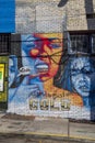 A colorful wall mural of two women wearing gold teeth in Little Five Points in Atlanta Georgia