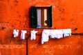 Colorful wall & window with drying clothes